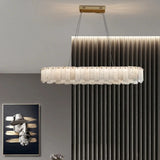 Marble ring chandelier above a console in a paneled room