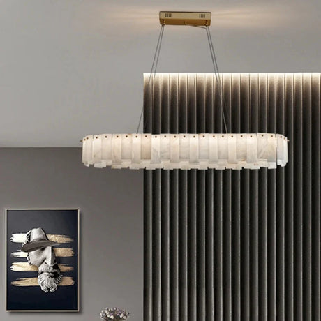 Marble ring chandelier above a console in a paneled room