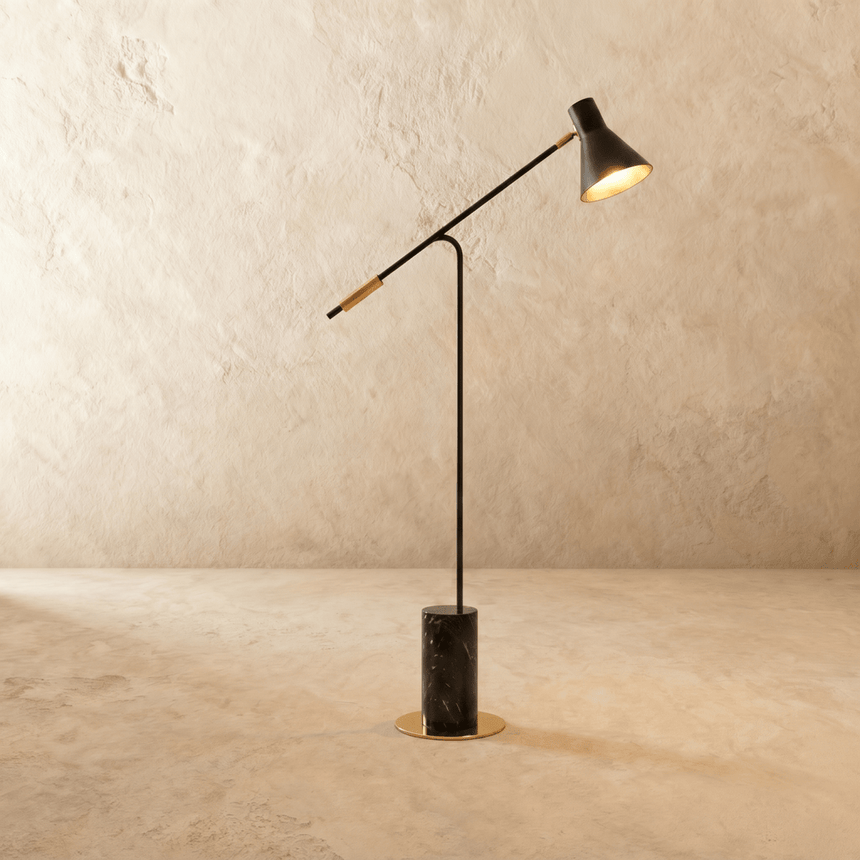 A long angled arm on a slim upright above a dark marble cylinder base