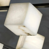 The corner of one alabaster cube, the veining lit from inside the stone