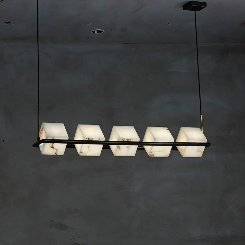 Five lit alabaster cubes in a straight row on a black bar, dark wall behind