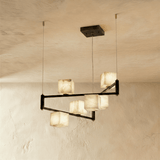 Alabaster cubes lit on two levels of black arms, staggered rather than in a row