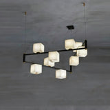 A staggered run of lit stone cubes on two black arms above a dark floor