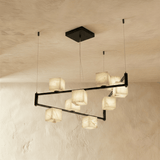 A tall staggered set of lit alabaster cubes spread across two black arms