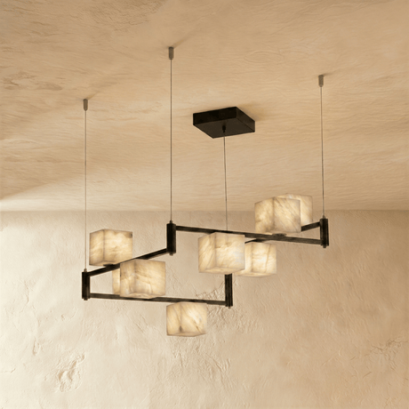 A wider staggered arrangement of lit stone cubes on black arms and cables