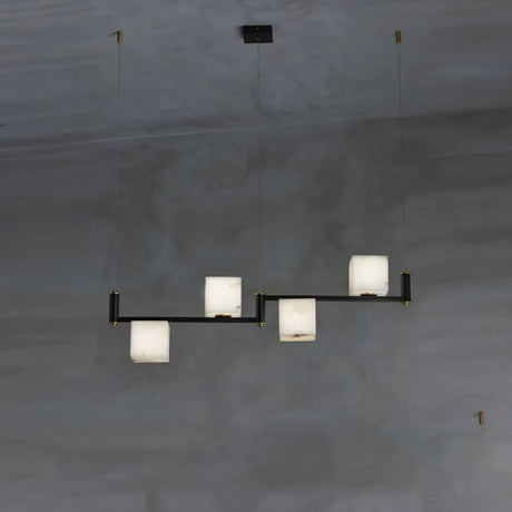 Three lit alabaster cubes stepped on a short black arm, dark wall behind