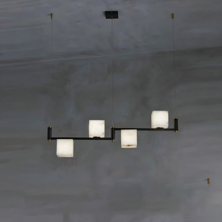 Three lit alabaster cubes stepped on a short black arm, dark wall behind