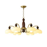 Shallow beige glass domes and the gold arms that carry them