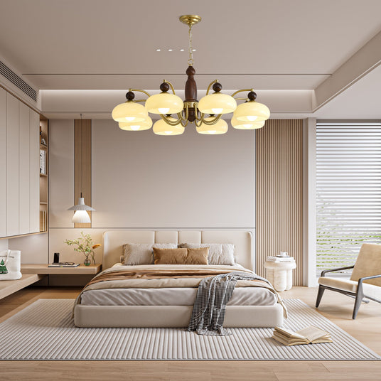 Chandelier lit in a bedroom above a made bed and two nightstands