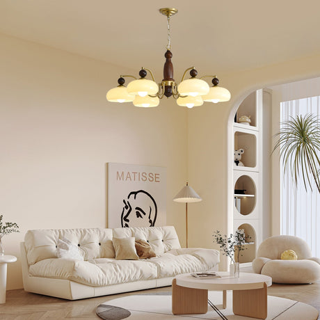 The domes lit above a deep sofa with framed art on the wall behind