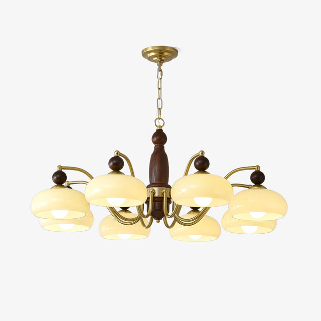 Mid century chandelier with brass arms and beige glass domes on walnut