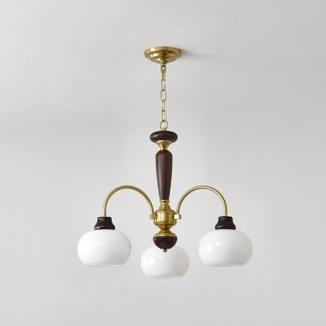 Chandelier lit warm, the opal globes glowing above a room corner