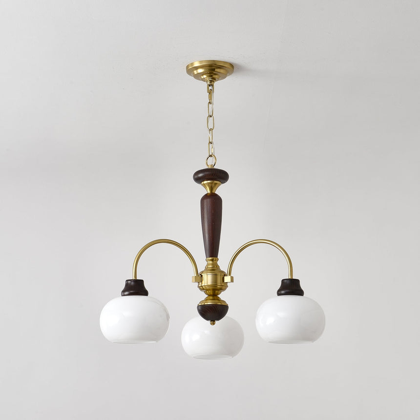 Chandelier lit warm, the opal globes glowing above a room corner