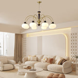 The fitting lit in a pale living room with a low sofa and framed art