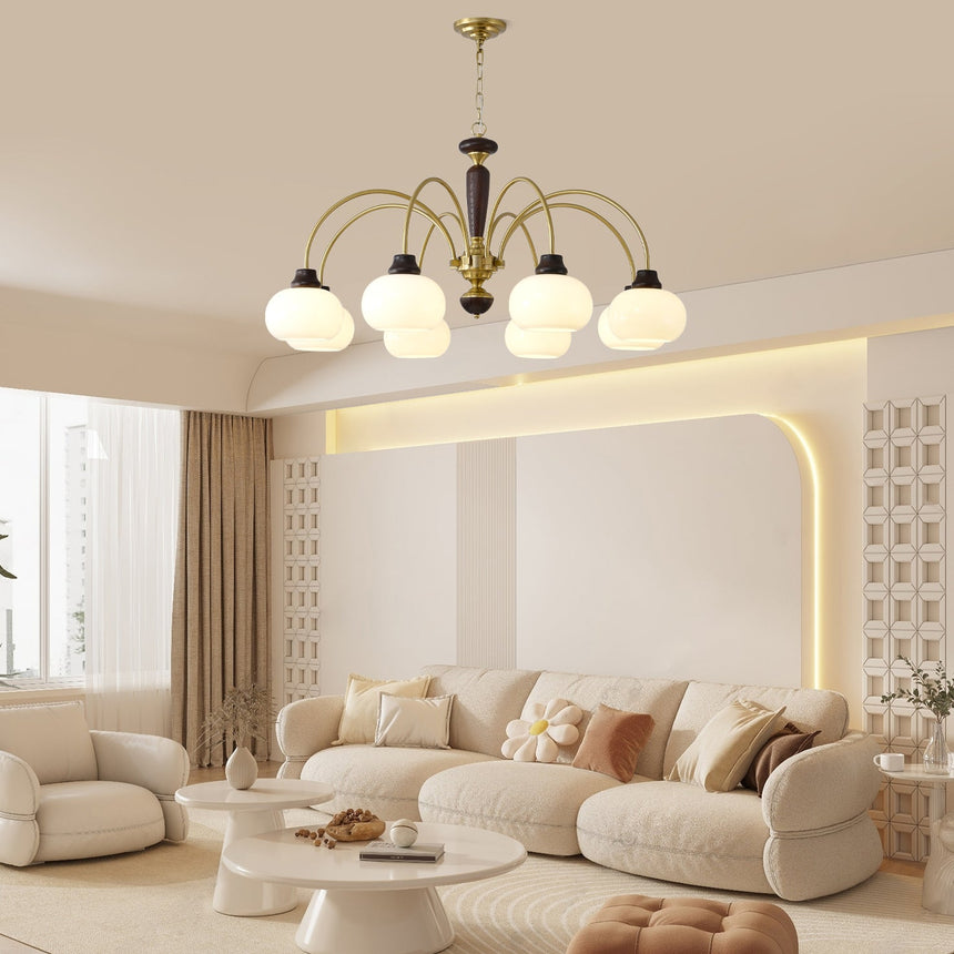 The fitting lit in a pale living room with a low sofa and framed art