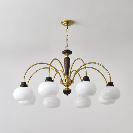 The white globes lit close, brass arms and walnut collars in view