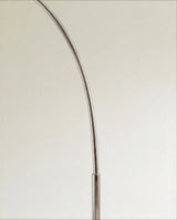 The polished chrome arm where it bends, showing the joint and the smooth finish