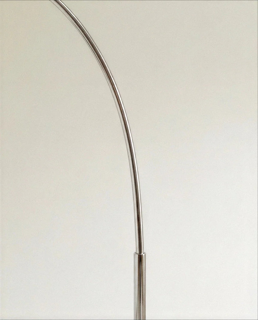 The polished chrome arm where it bends, showing the joint and the smooth finish