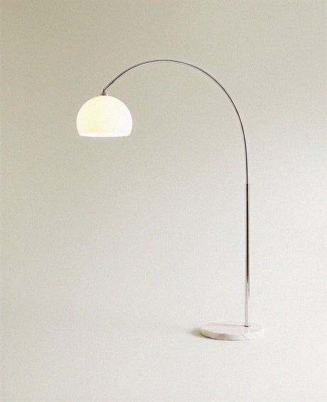 The glass dome unlit in cream, held by the chrome arm above the stone base