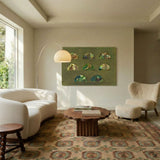 The white dome lit in a living room with artwork, a sofa, a rug and armchairs