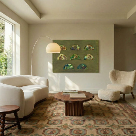 The white dome lit in a living room with artwork, a sofa, a rug and armchairs