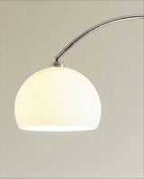 The white glass dome lit from within, the chrome arm curving away above it