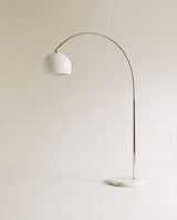 A curved chrome arm carrying a white glass dome above a round white marble base