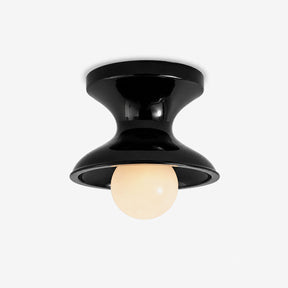 Mid century modern flush mount ceiling light with a glossy navy spool shade