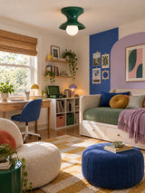 Green spool ceiling light in a child bedroom with blue and lilac walls