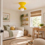 Yellow spool ceiling light in a child bedroom with woven blinds and shelves