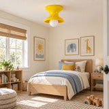 Yellow spool ceiling light in a child bedroom with a striped bed cover