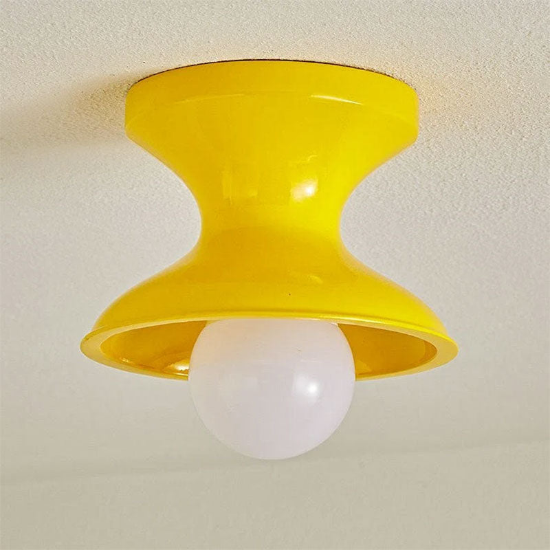 Close view of the yellow spool ceiling light with a round opal globe