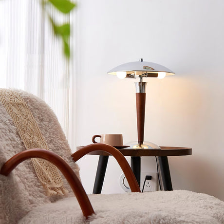 Chrome dome table lamp on a small table beside a bentwood armchair