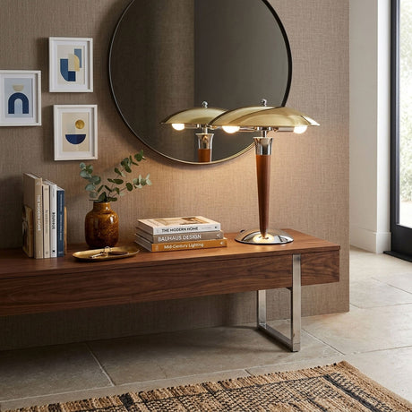 Chrome dome table lamp on a sideboard in front of a round mirror