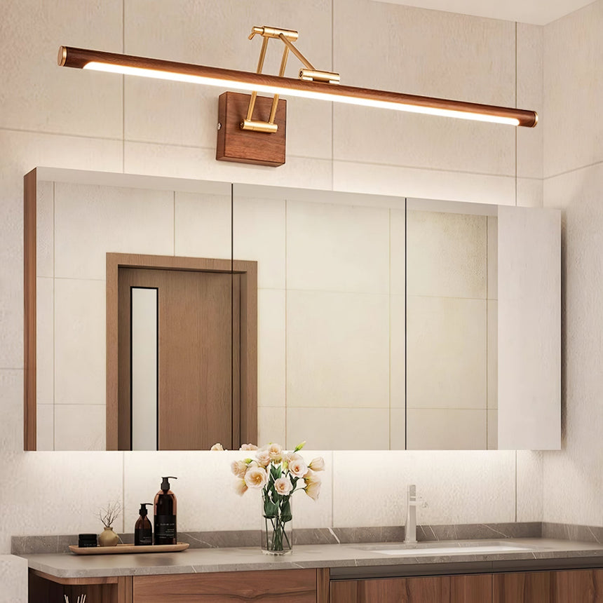 Bar lit above a framed mirror over a stone counter with flowers and bottles