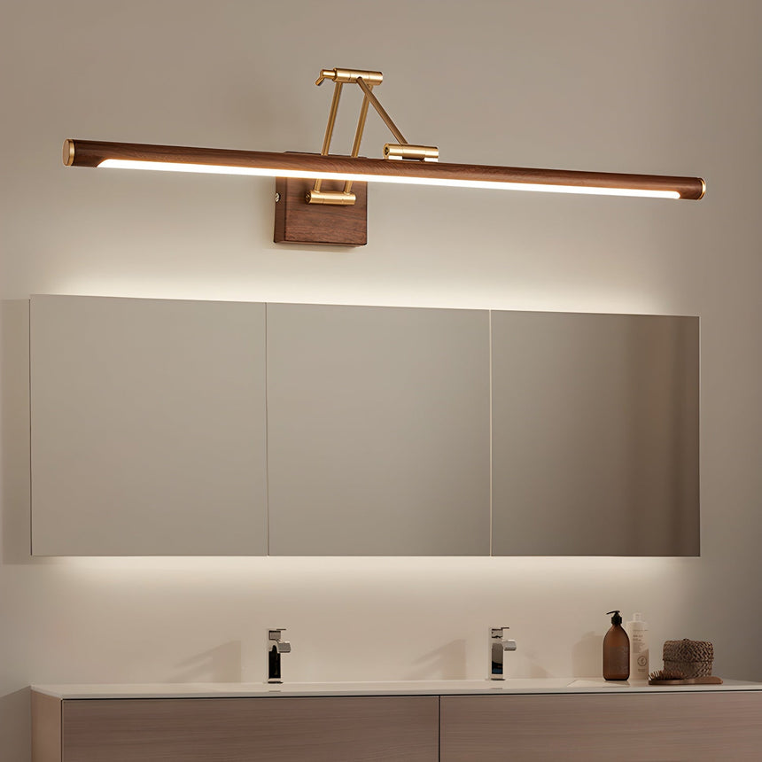 Walnut toned bar lit above a long mirror over a wide vanity with two basins
