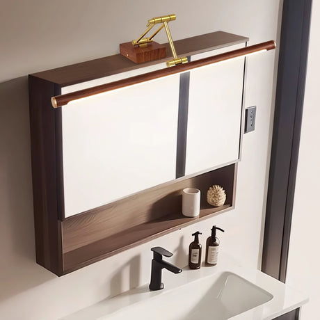 Bar lit above a walnut mirror cabinet over a basin with a black tap