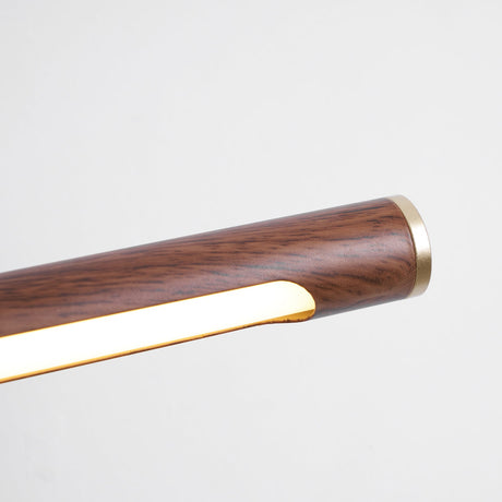 Close view of the walnut toned tube end with its brass cap and lit diffuser