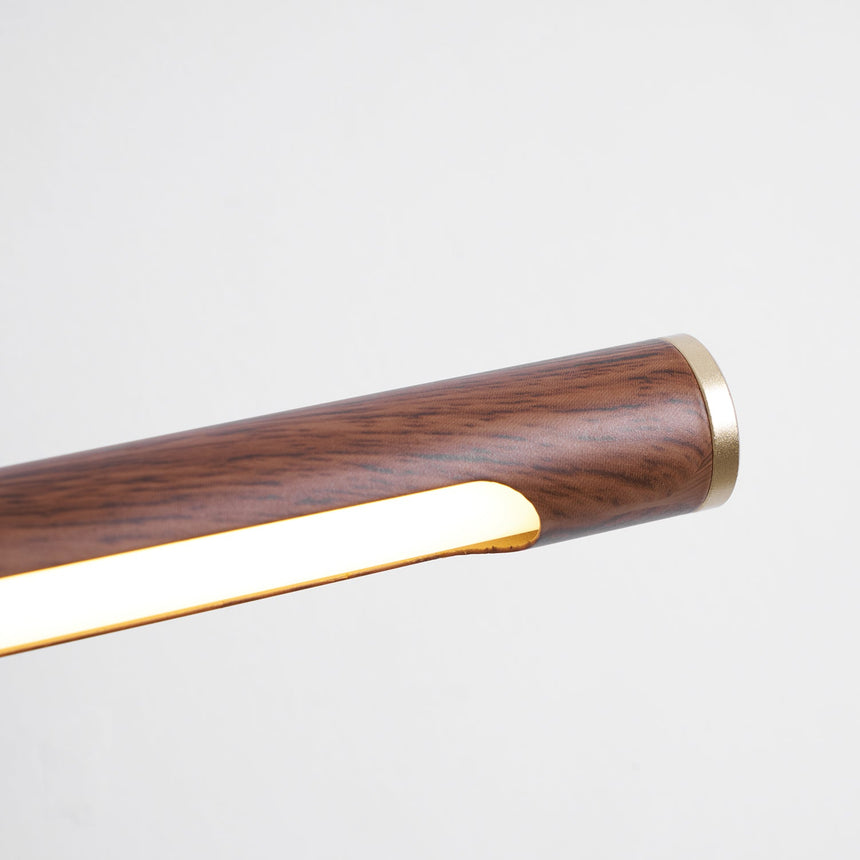 Close view of the walnut toned tube end with its brass cap and lit diffuser