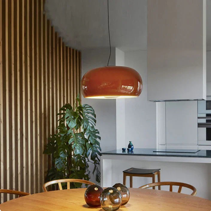 Red glass dome above a wooden dining table