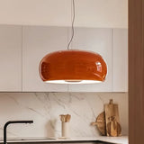 Red glass dome pendant above a marble kitchen counter