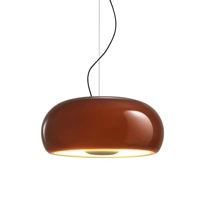 Red glass dome shade photographed against a pale ground