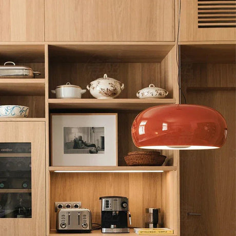 Red glass dome in front of an oak shelving unit