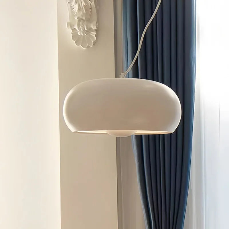White glass dome hung beside a deep blue curtain
