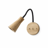 Light wood cone head on a black gooseneck arm and a round wood plate