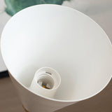 Looking up into the cone shade at the white socket waiting for a lamp