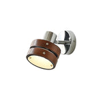 The walnut drum seen from the front, its frosted lens facing down