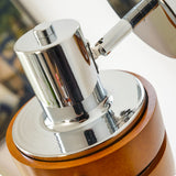 Close view of the chrome ball joint that carries the walnut head