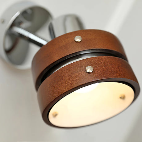 The frosted lens lit warm under the walnut drum head, seen close