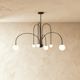 The black frame turned so the arched arms cross and the globes sit at depth